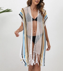 Detail of bohemian crochet beach cover-up with multicolored stripes and fringe hem