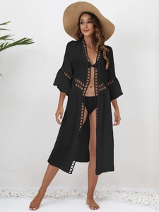 Close-up of black beach cover-up featuring intricate circular hollow lace and woven details
