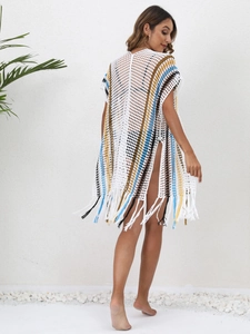 Detailed knit pattern of Bohemian beach cover-up with color-block stripes and long fringes
