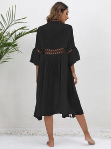Detailed view of bohemian black beach cover-up with crochet lace trim and bell sleeves