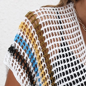 Detail of colorful striped crochet pattern on a white mesh bohemian beach cover-up