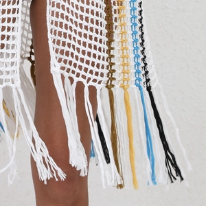 Detail shot of multicolor striped crochet beach cover-up with long decorative fringe tassels