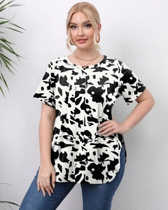 Close-up of women's plus size cow print T-shirt with stylish side split hem detail