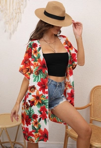 Close-up of lightweight chiffon fabric with vibrant tropical floral and leaf prints