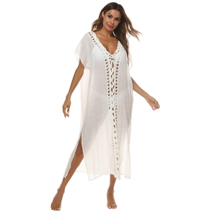 Detail of white crochet lace trim and deep V-neck tie on sheer beach maxi dress