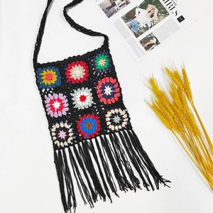 Handmade crochet shoulder bag with colorful floral squares and black tassel trim