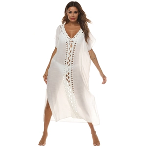 Detail of white crochet v-neckline and sheer lace fabric on long beach cover-up dress