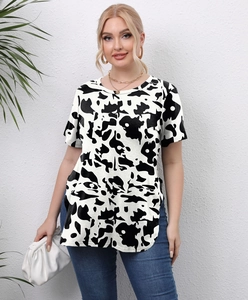 Detail shot of plus size T-shirt featuring cow print and a stylish curved side hem