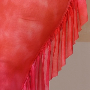 Detailed macro view of red gradient fabric featuring elegant ruffled edges and mesh texture