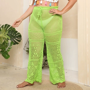 Detail of neon green crochet knit wide leg beach pants featuring drawstring waist