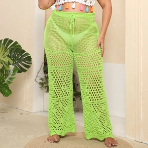Detail of neon green crochet knit wide-leg beach trousers with hollow-out mesh texture