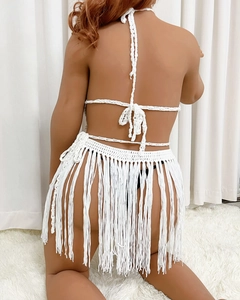 Close-up of white crochet beach set showing back detail and long fringe skirt texture
