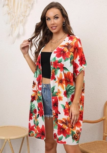 Detail of floral chiffon beach cover-up with vibrant lily print and loose kimono sleeves