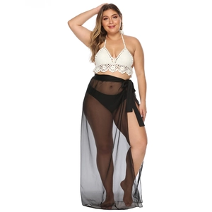 Detail of white crochet halter bikini top and sheer black chiffon wrap skirt with high slit