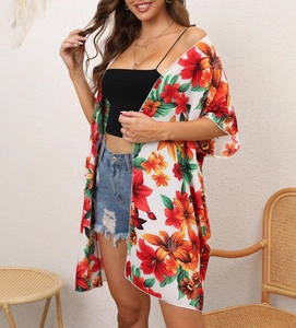 Detailed close-up of a floral print chiffon cover-up showing tropical lily pattern