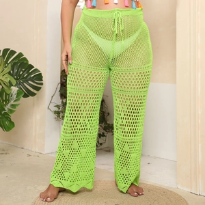 Detail of neon green crochet knit mesh beach pants with drawstring waist and wide leg