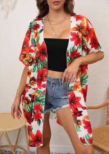 Detail of floral print chiffon beach kimono with tropical orange hibiscus and green leaves