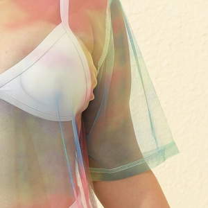 Detailed texture of rainbow mesh beach cover-up with sheer gradient fabric and stitching