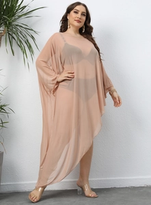 Detail of sheer mesh beach cover-up showing light pink fabric and irregular layered hemline