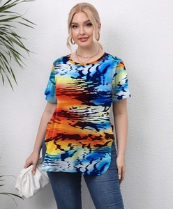 Detail of plus size top featuring colorful abstract sunset print and side slit design