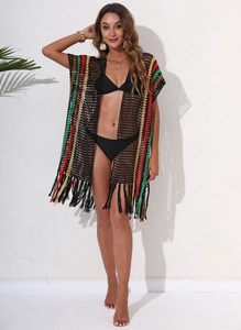 Detail of crochet beach cover-up featuring colorful stripes and fringe hemline