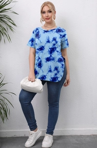 Detail view of side slit and blue tie-dye pattern on a casual plus size women's t-shirt