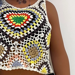 Close-up of vibrant handmade crochet crop top with colorful granny square patterns
