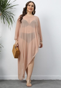 Macro detail of sheer mesh fabric and asymmetrical hem on this pink beach cover-up dress