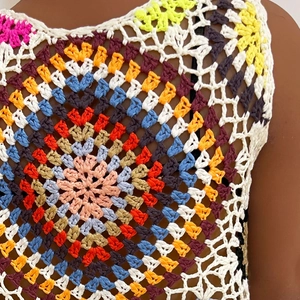 Close-up of handmade crochet mandala pattern with colorful vintage boho stitching