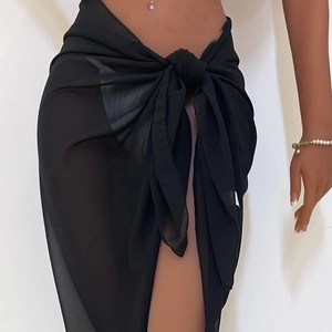Detail of sheer black chiffon beach sarong featuring a side-tie waist and wrap design