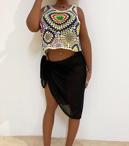 Bohemian colorful crochet crop top and black sheer chiffon sarong skirt for beach vacation