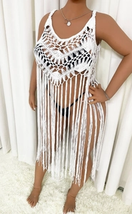 Detail of white crochet beach cover-up with V-neck hollow knit and long tassel fringe
