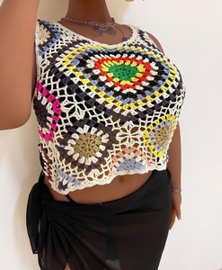 Close-up of handmade crochet crop top with bohemian colorful hollow knit texture