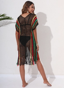 Detail of crochet beach cover-up featuring colorful stripes and bohemian fringe tassels