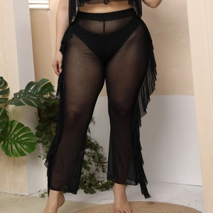 Detailed close-up of ruffle side trim on black sheer mesh beach cover-up pants