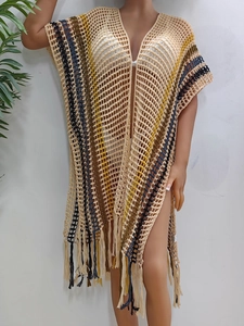 Detailed knit texture of colorful striped crochet beach cover-up with long tassels