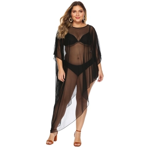 Detail of sheer black mesh beach cover-up with batwing sleeves and asymmetrical hemline