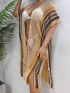 Close-up of crochet hollow mesh fabric with colorful stripes and tassel details