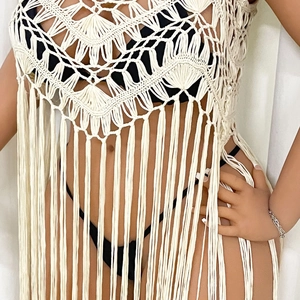 Detail of handmade cream crochet beach cover-up featuring intricate fan-shaped hollow patterns