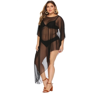 Detail showing the sheer mesh fabric and asymmetric hemline of the black beach cover-up