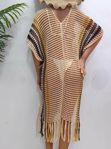 Detailed knit texture of crochet beach cover-up with colorful stripes and long tassels