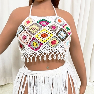 Detail of crochet bikini top with colorful patchwork and white pearl fringe tassels