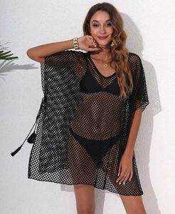 Detail of black crochet fishnet beach cover-up featuring side fringe drawstring details