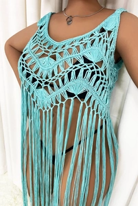 Detail of light blue crochet tassel cover-up featuring geometric openwork patterns