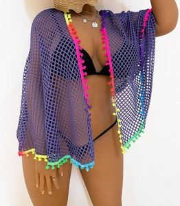 Detail of purple mesh beach cover-up featuring vibrant multicolor pom-pom trim and fringes
