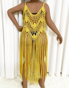 Detailed back view of yellow crochet beach cover-up with fringe tassels and deep V-back