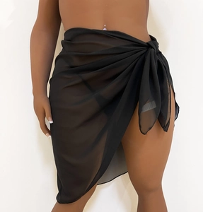 Detail of black sheer mesh sarong showing the side-tie closure and lightweight fabric texture