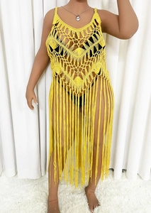 Detailed view of yellow crochet beach cover-up with hollow knit and boho fringe hem