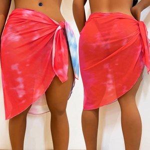Detail of red tie-dye sheer mesh beach sarong featuring side tie and breathable fabric