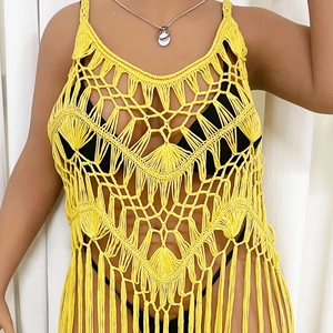 Detailed macro view of yellow crochet cover-up dress with intricate fringe and knit pattern